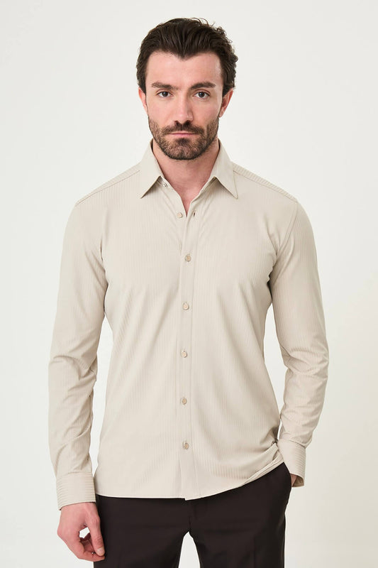 Beige slim-fit long sleeve men’s shirt with subtle stripes, worn with dark trousers, front view.
