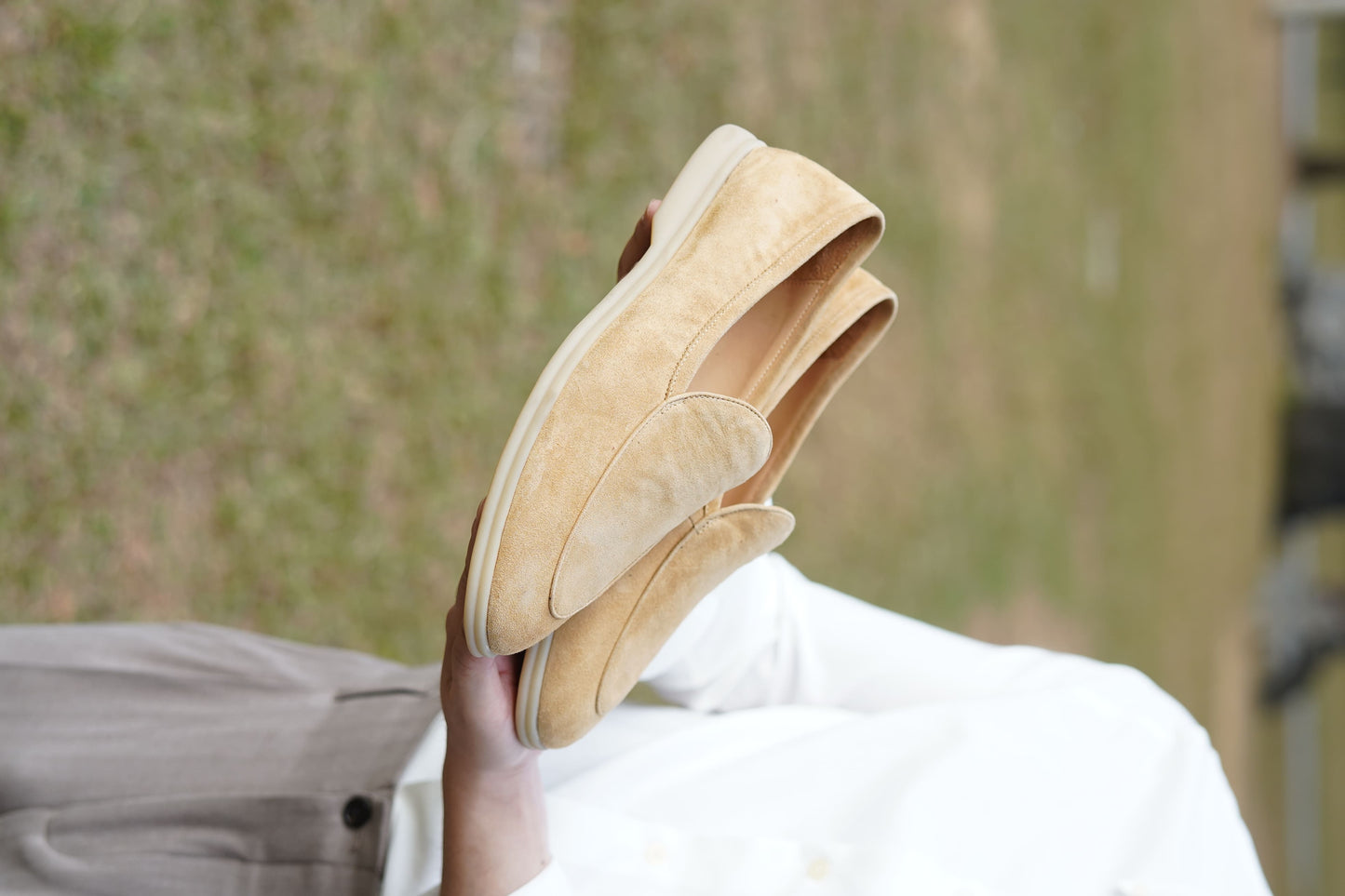 Men’s beige suede slip-on loafers featuring a minimalist apron vamp design and lightweight cream sole, perfect for smart-casual summer outfits.
