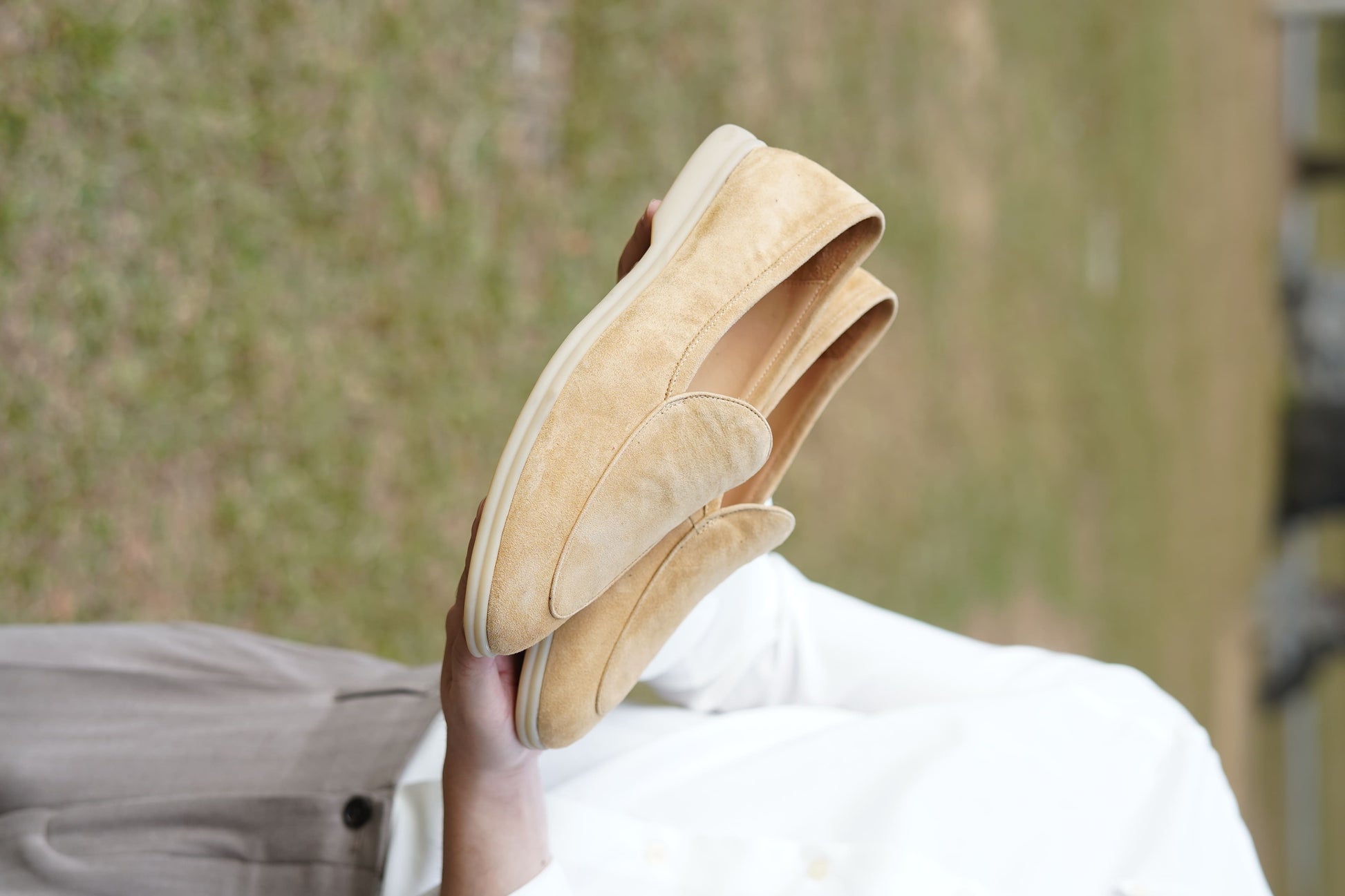Men’s beige suede slip-on loafers featuring a minimalist apron vamp design and lightweight cream sole, perfect for smart-casual summer outfits.