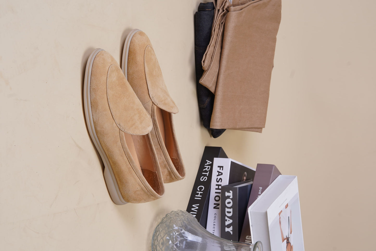 Men’s beige suede slip-on loafers featuring a minimalist apron vamp design and lightweight cream sole, perfect for smart-casual summer outfits.