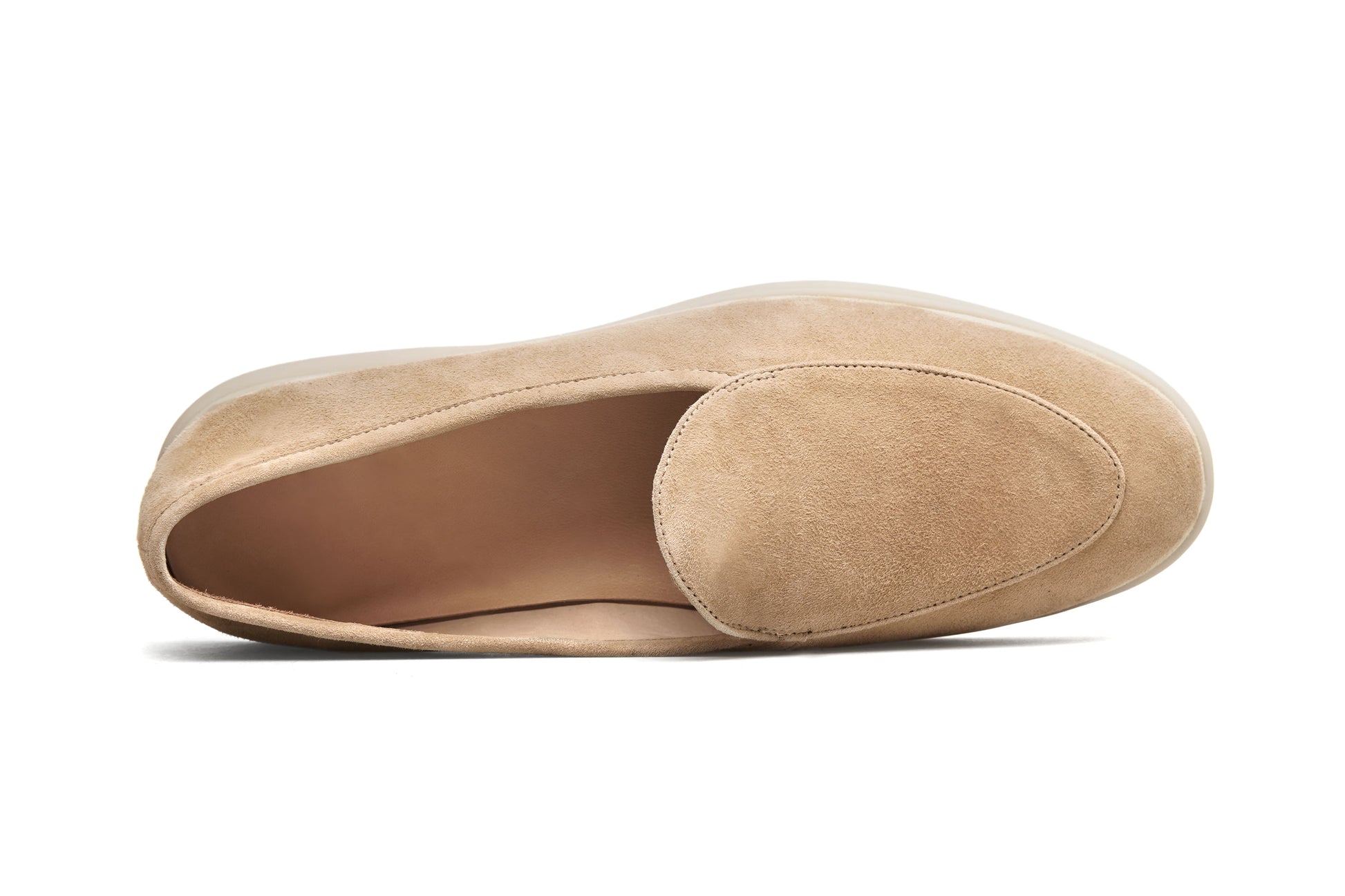 Men’s beige suede slip-on loafers featuring a minimalist apron vamp design and lightweight cream sole, perfect for smart-casual summer outfits.