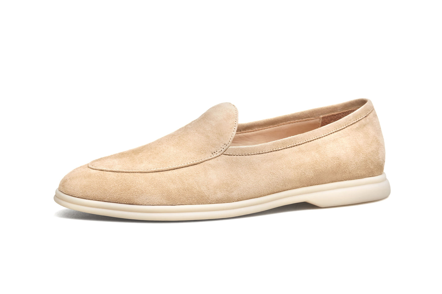 Men’s beige suede slip-on loafers featuring a minimalist apron vamp design and lightweight cream sole, perfect for smart-casual summer outfits.