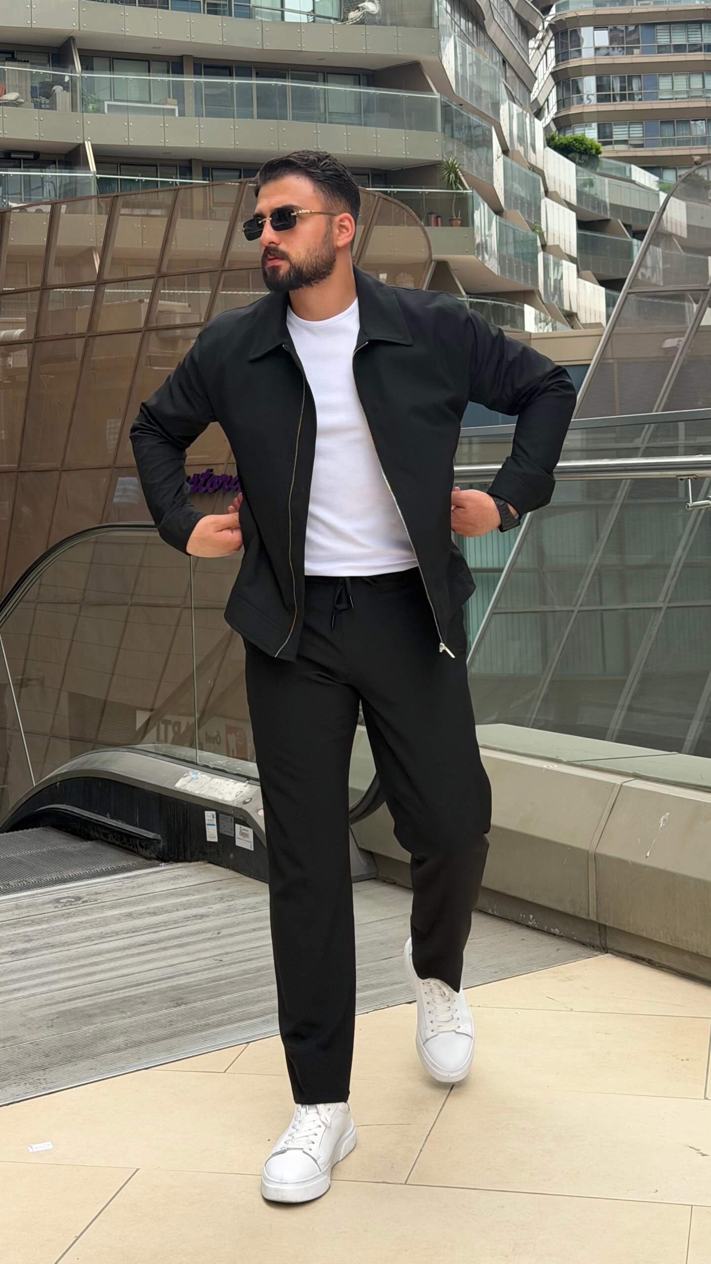 slim-fit black zip-up jacket with matching tailored trousers