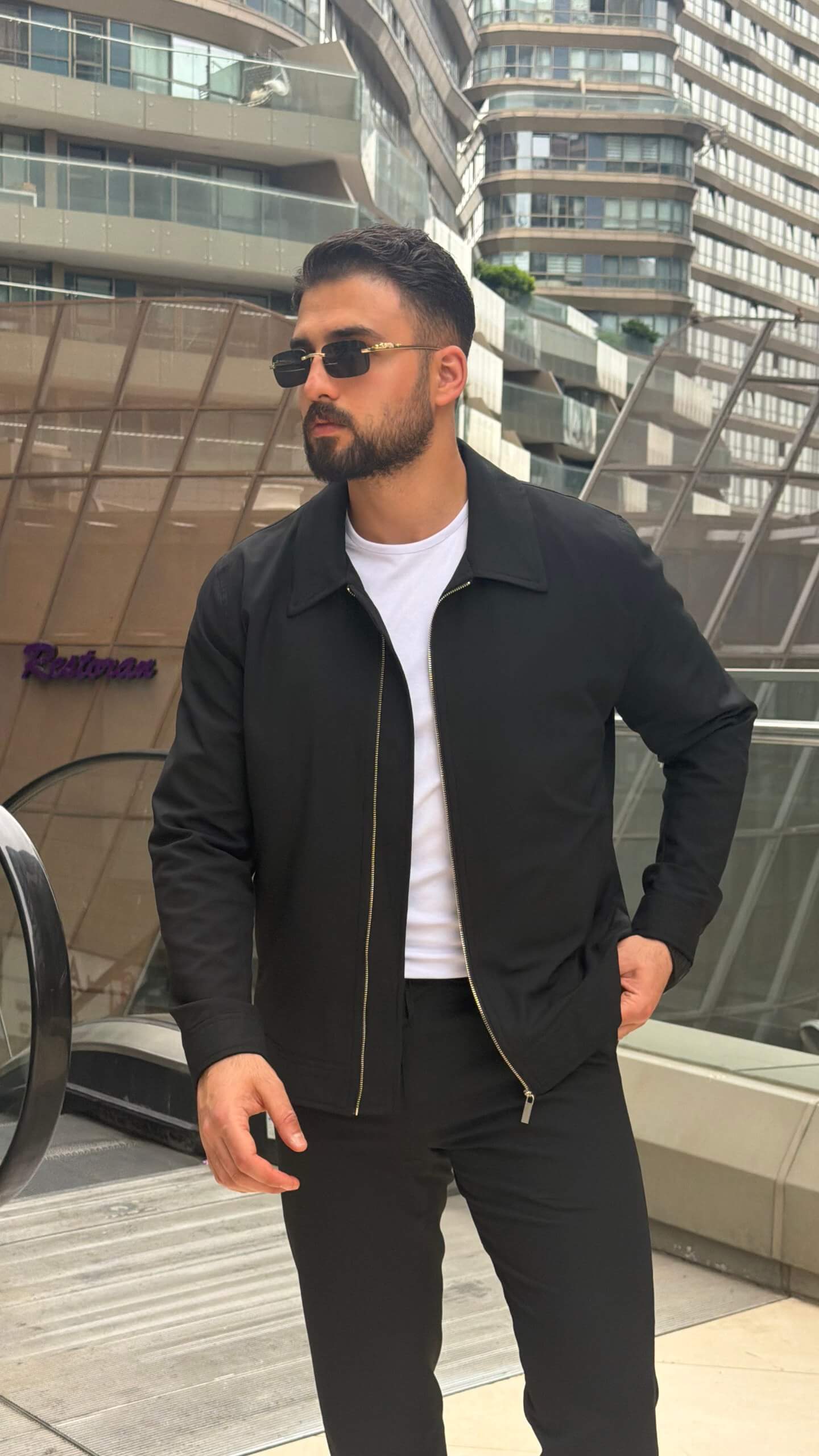 slim-fit black zip-up jacket with matching tailored trousers
