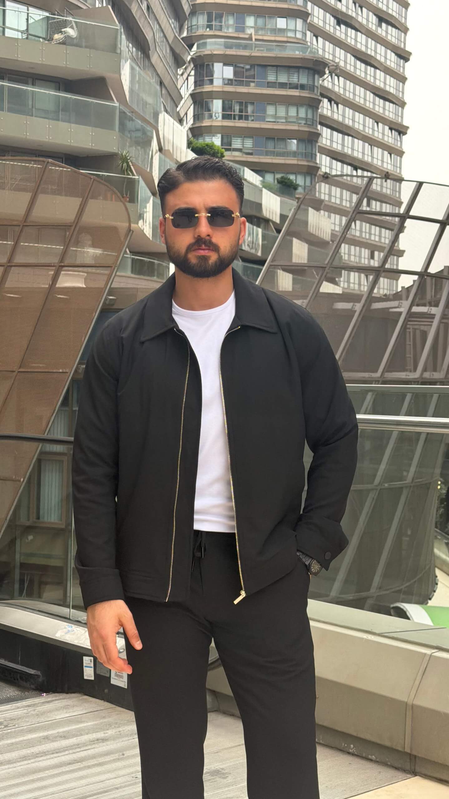 slim-fit black zip-up jacket with matching tailored trousers