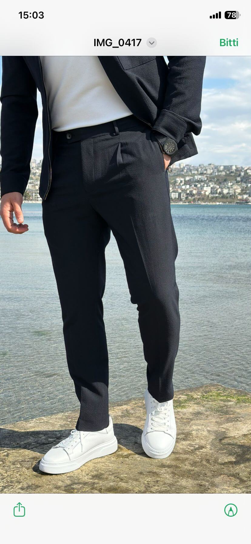 Men’s navy blue cargo co-set featuring a cargo shacket with multiple pockets and matching tracksuit pants, worn outdoors with white sneakers, showcasing a relaxed look.