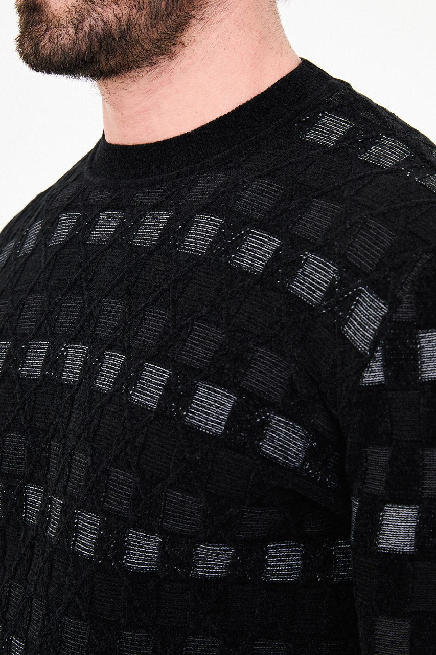 Men's black checkered textured crew neck knit sweater with patterned design for fall winter menswear.