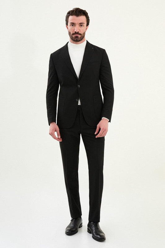 Men’s black mono-collar slim-fit suit with band/mandarin neckline, matte finish tailoring, single-breasted jacket styled with a white turtleneck, travel-ready stretch wool-viscose blend.