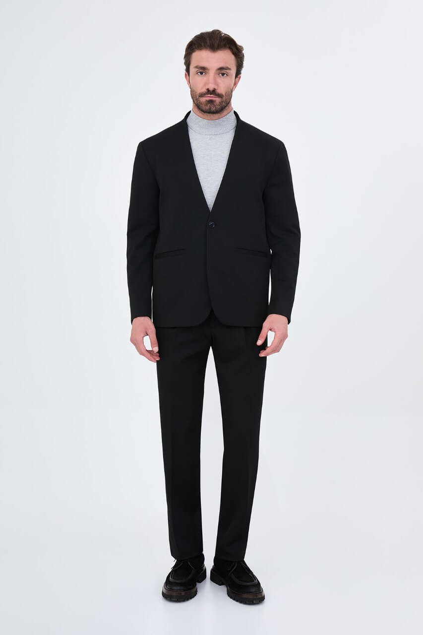 HolloMen men's black casual two-piece suit featuring a minimalist single-button jacket and matching trousers styled with a grey turtleneck.
