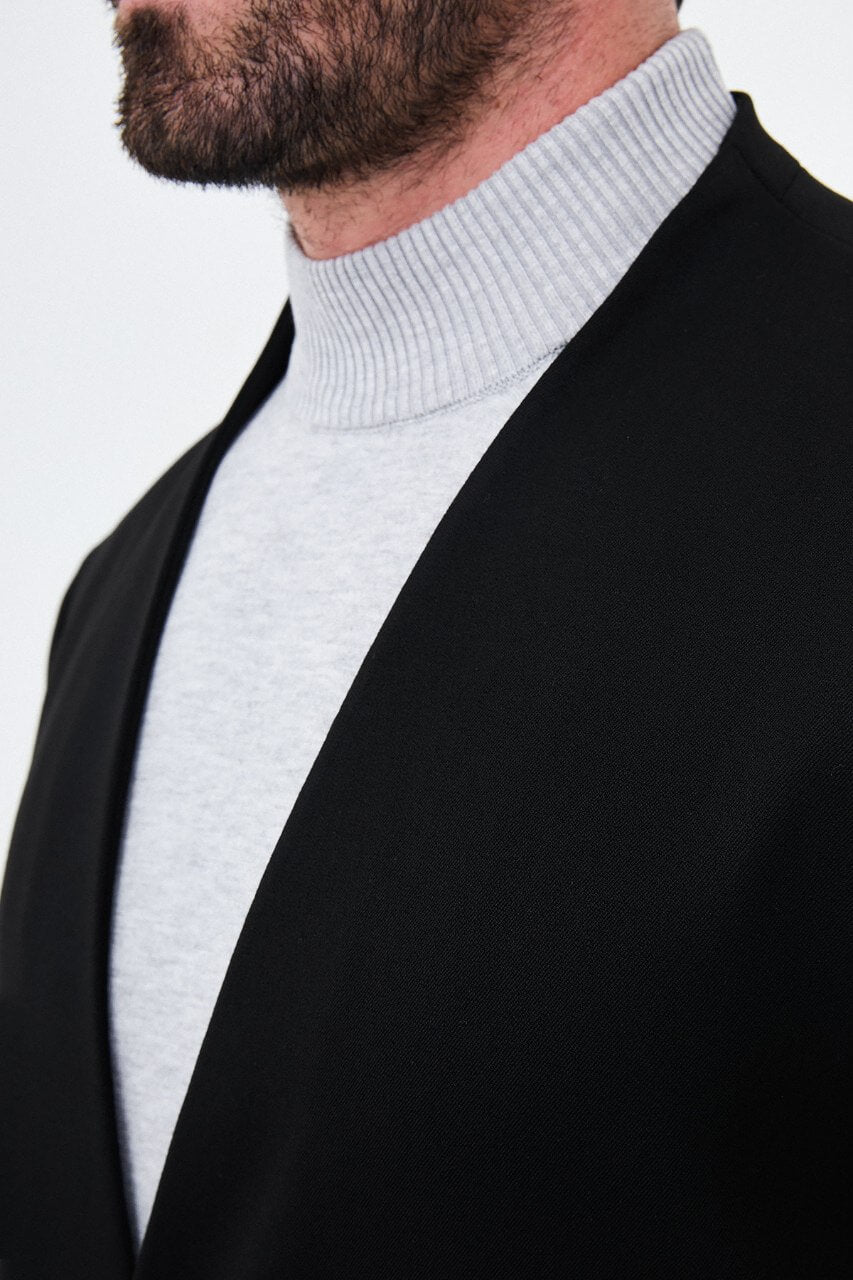 HolloMen men's black casual two-piece suit featuring a minimalist single-button jacket and matching trousers styled with a grey turtleneck.