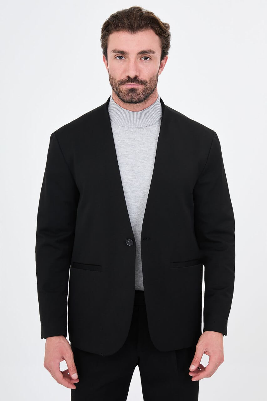 HolloMen men's black casual two-piece suit featuring a minimalist single-button jacket and matching trousers styled with a grey turtleneck.