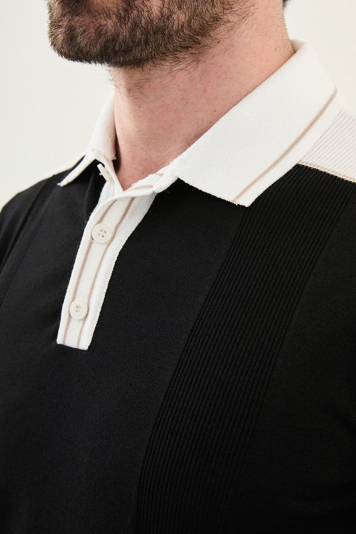 Men’s black colorblock slim fit knit polo shirt with contrast collar styled for modern summer smart-casual wear.