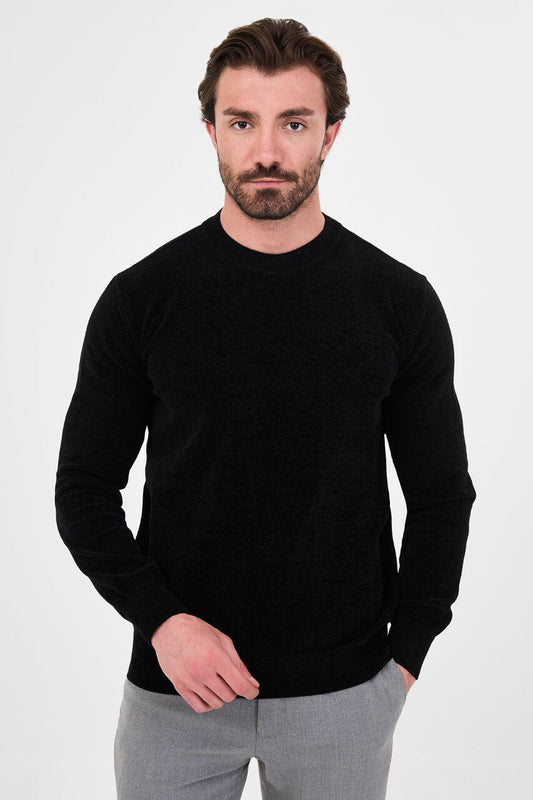 Men’s black crew neck knit sweater in a cotton blend slim fit design styled with grey trousers for a refined fall winter outfit.