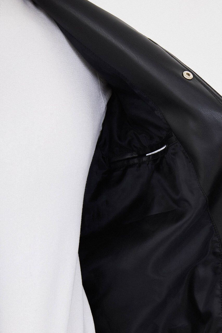 Men's black PU leather jacket styled with black trousers and a white crew-neck T-shirt.