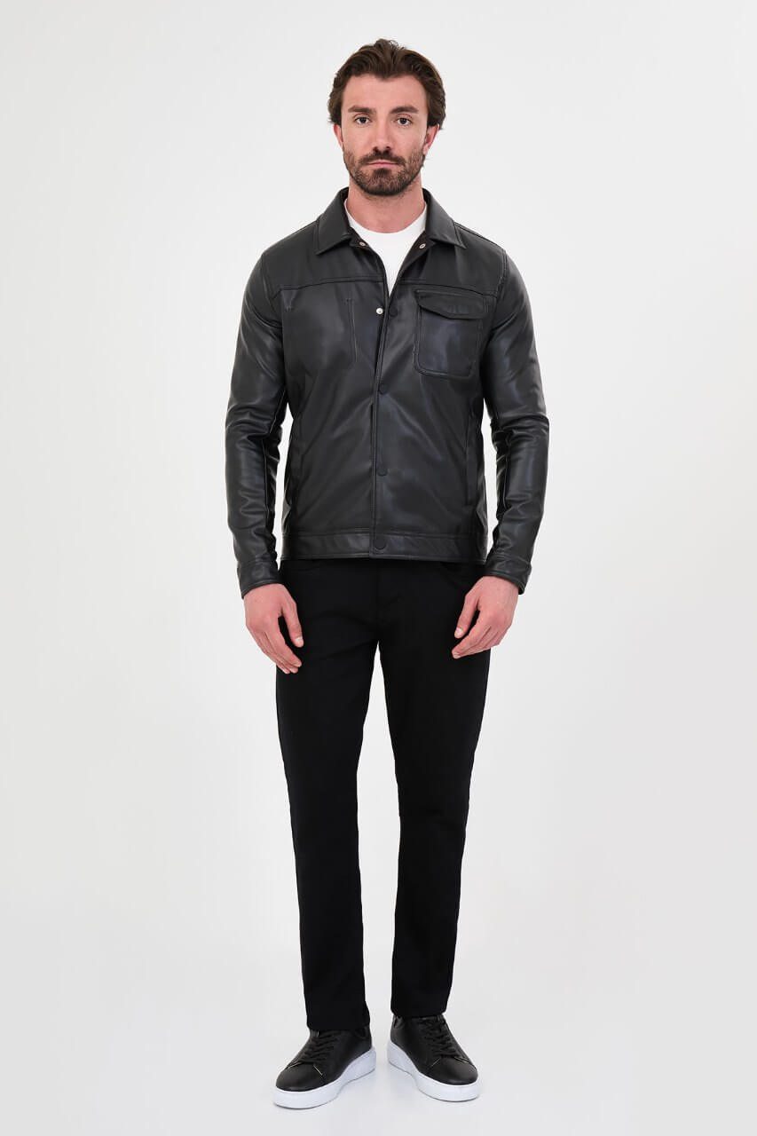 Men's black PU leather jacket styled with black trousers and a white crew-neck T-shirt.