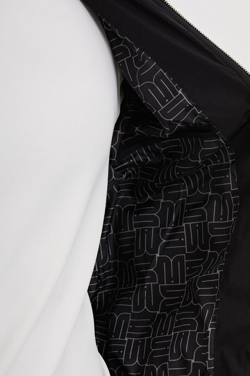 Black men's casual jacket styled with a white T-shirt and grey trousers.