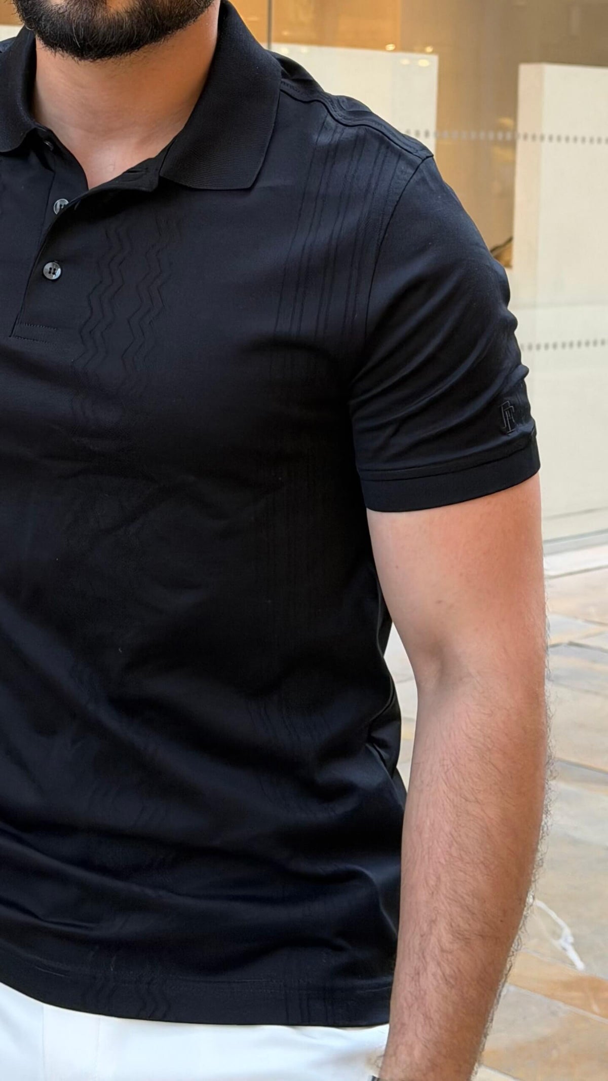 Men’s black knitted pure cotton polo shirt with textured smart-casual design