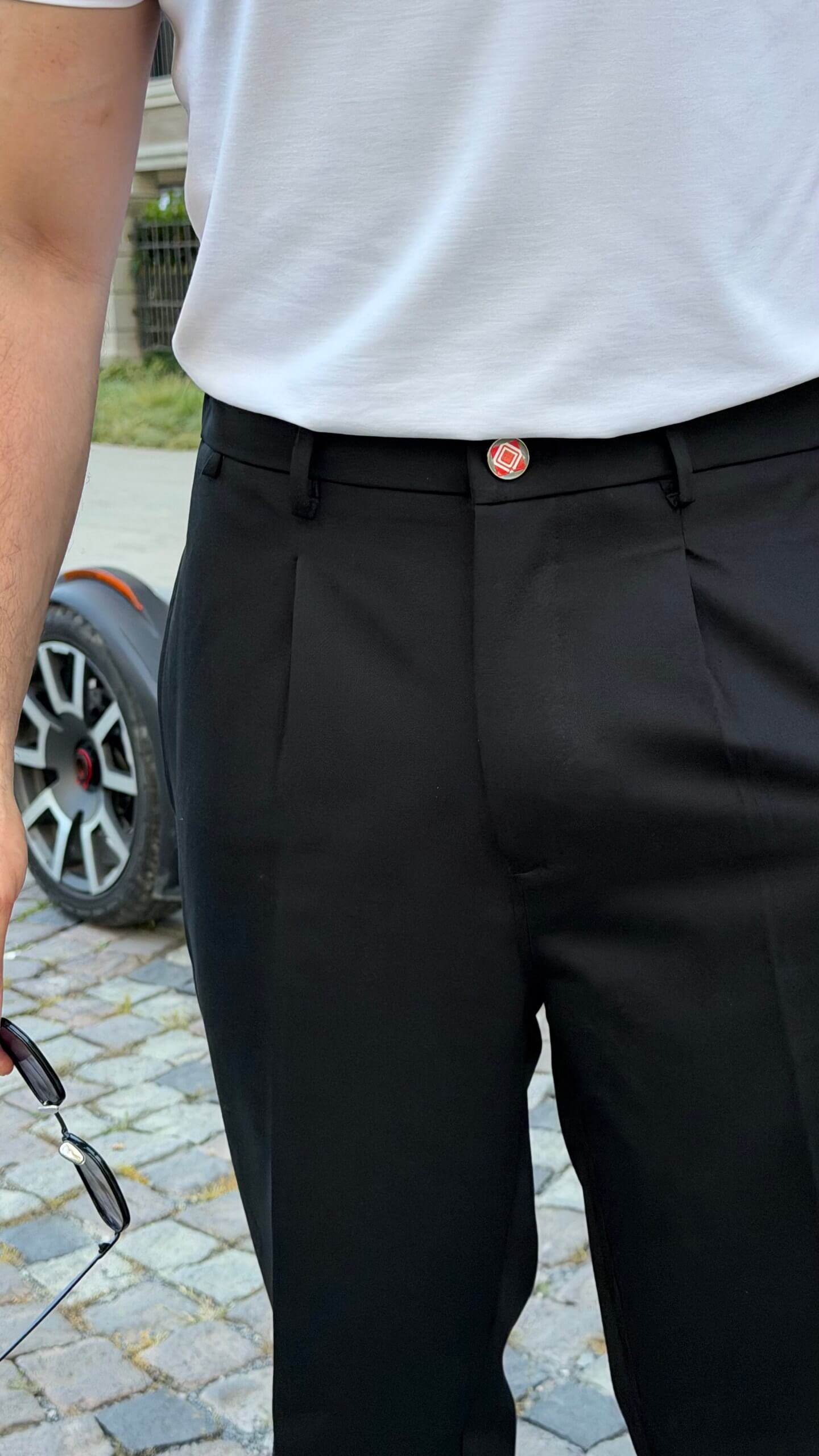 Black pleated tailored trousers, side view