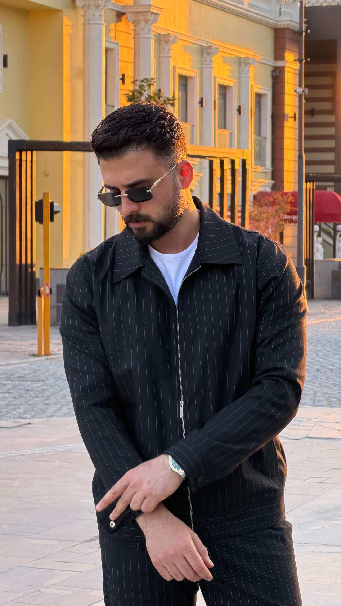 black pinstripe cargo co-set outfit, featuring a zip-front slim-fit jacket with matching cargo pants