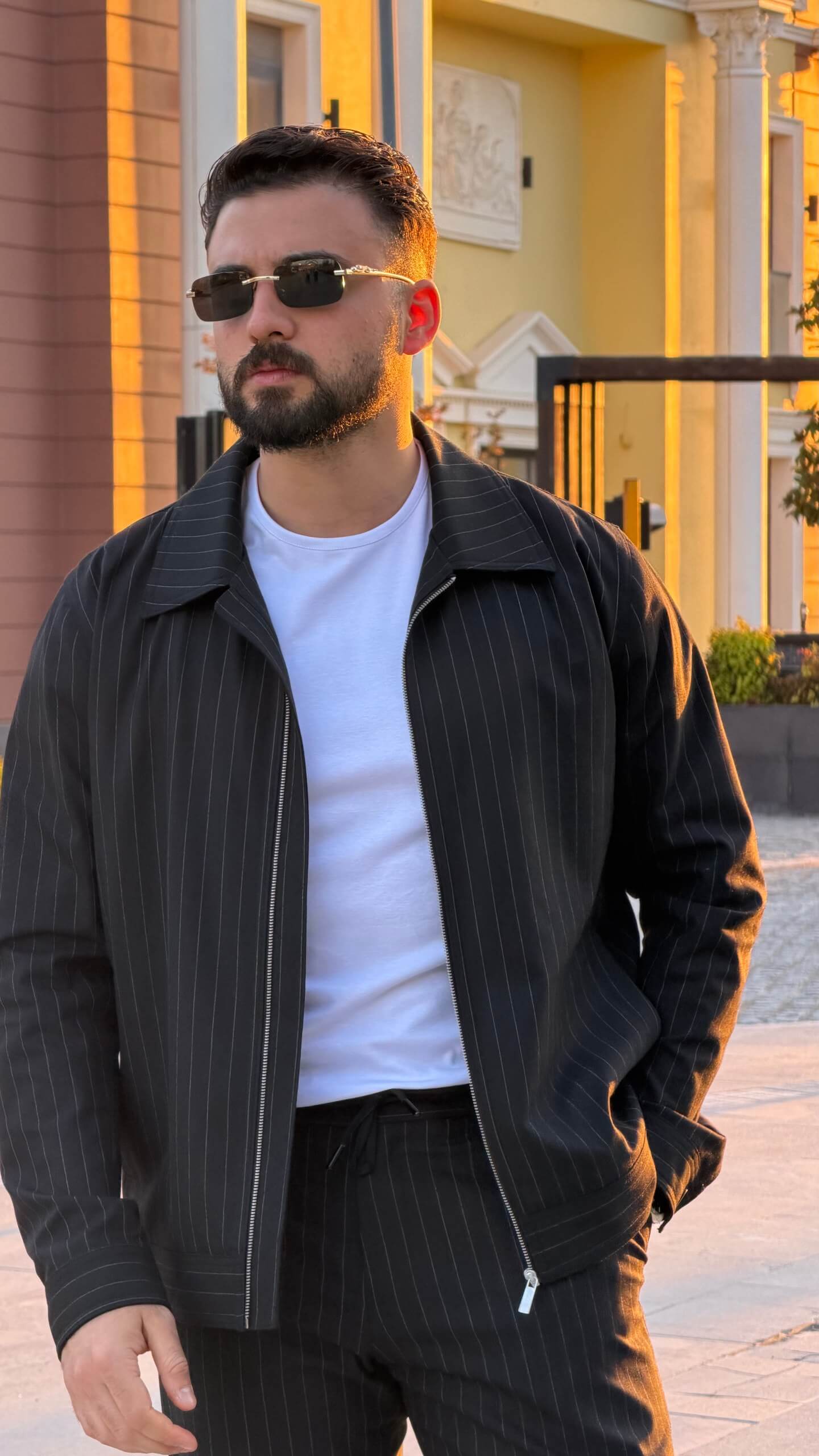 black pinstripe cargo co-set outfit, featuring a zip-front slim-fit jacket with matching cargo pants