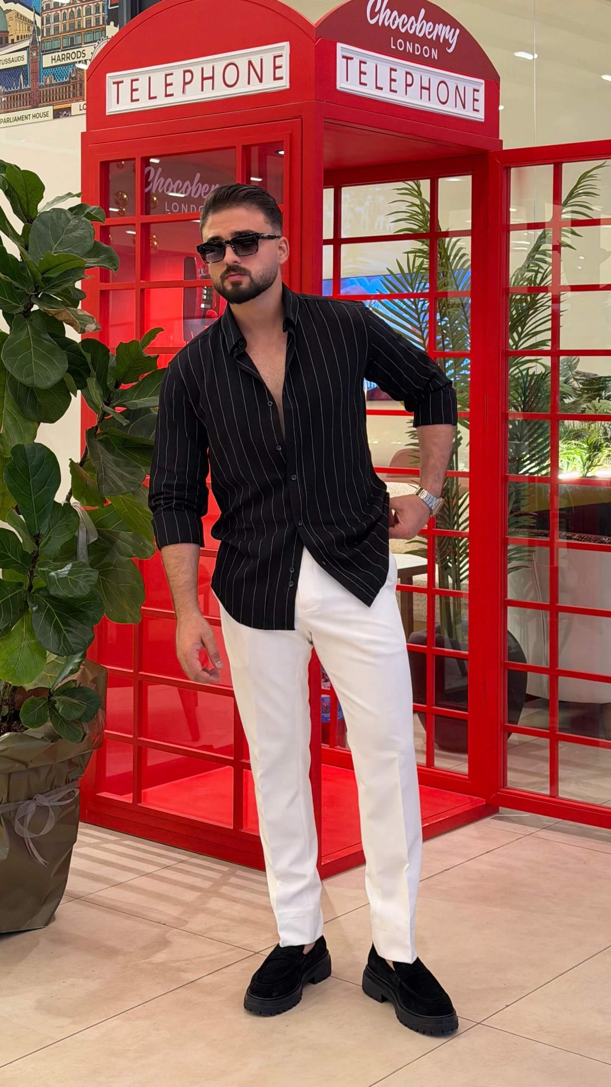 Men’s black pinstripe long sleeve cotton shirt styled with white trousers and black loafers