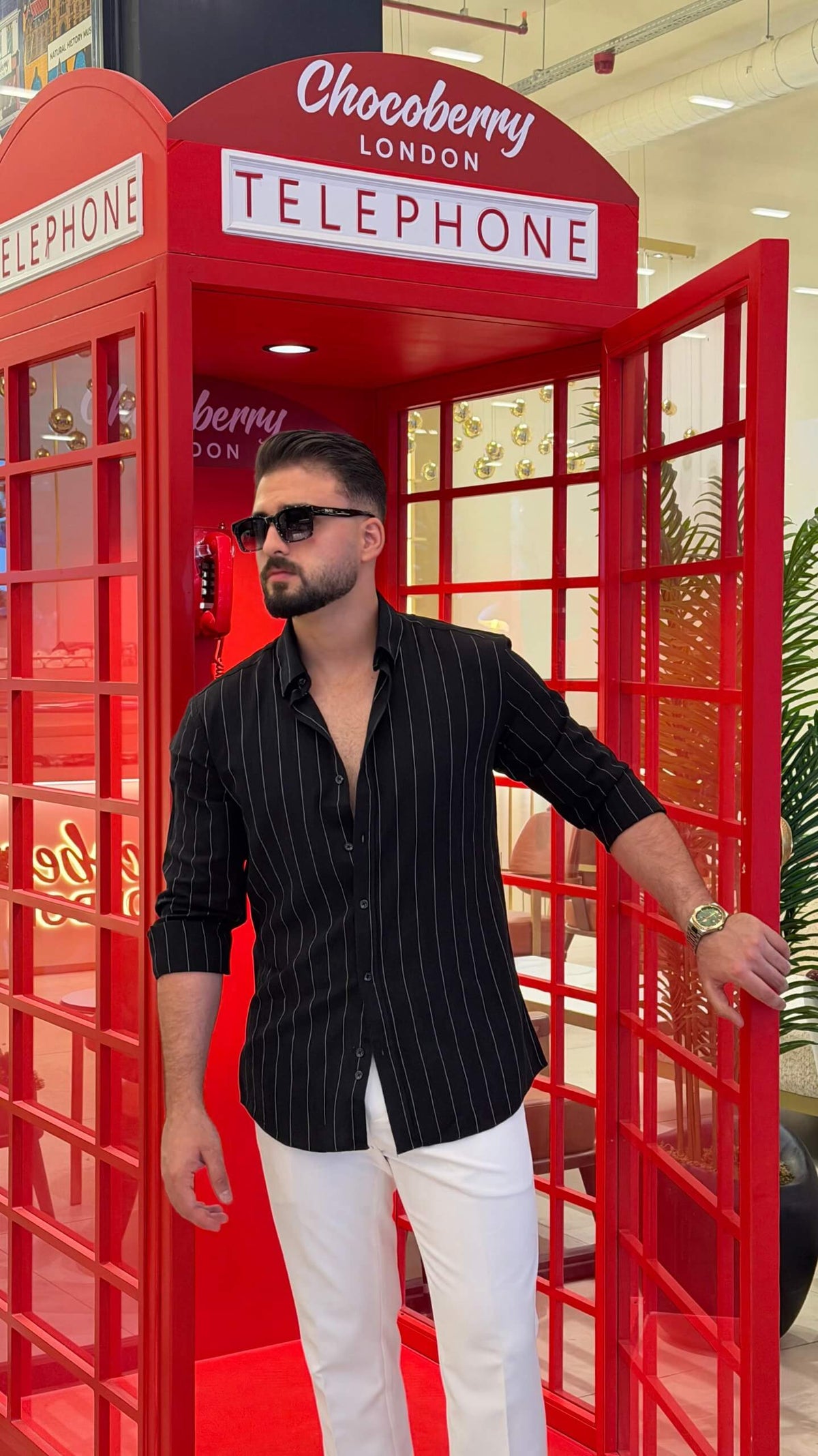 Men’s black pinstripe long sleeve cotton shirt styled with white trousers and black loafers