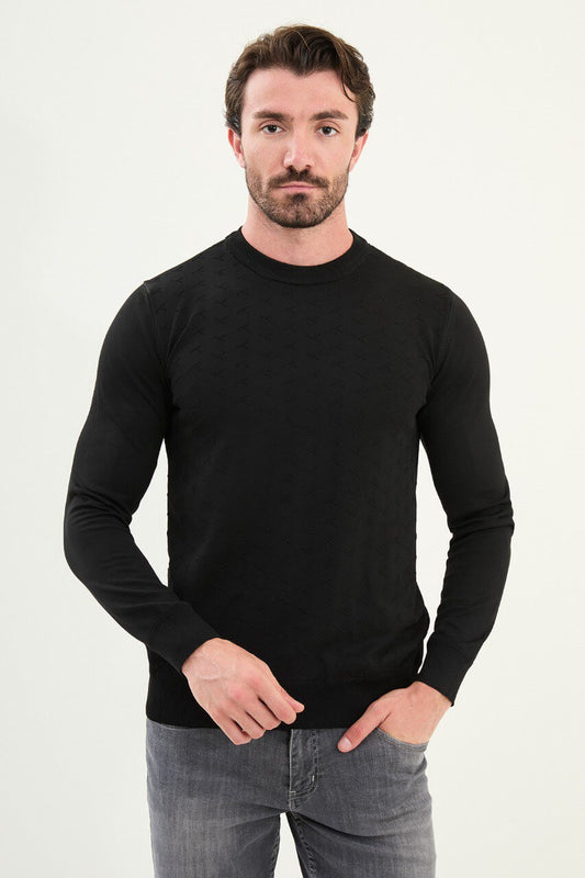 Men’s slim-fit black crew-neck sweater with geometric ‘T’ textured knit front panel, cotton-viscose-elastane blend, styled with charcoal gray denim in a monochrome winter outfit.