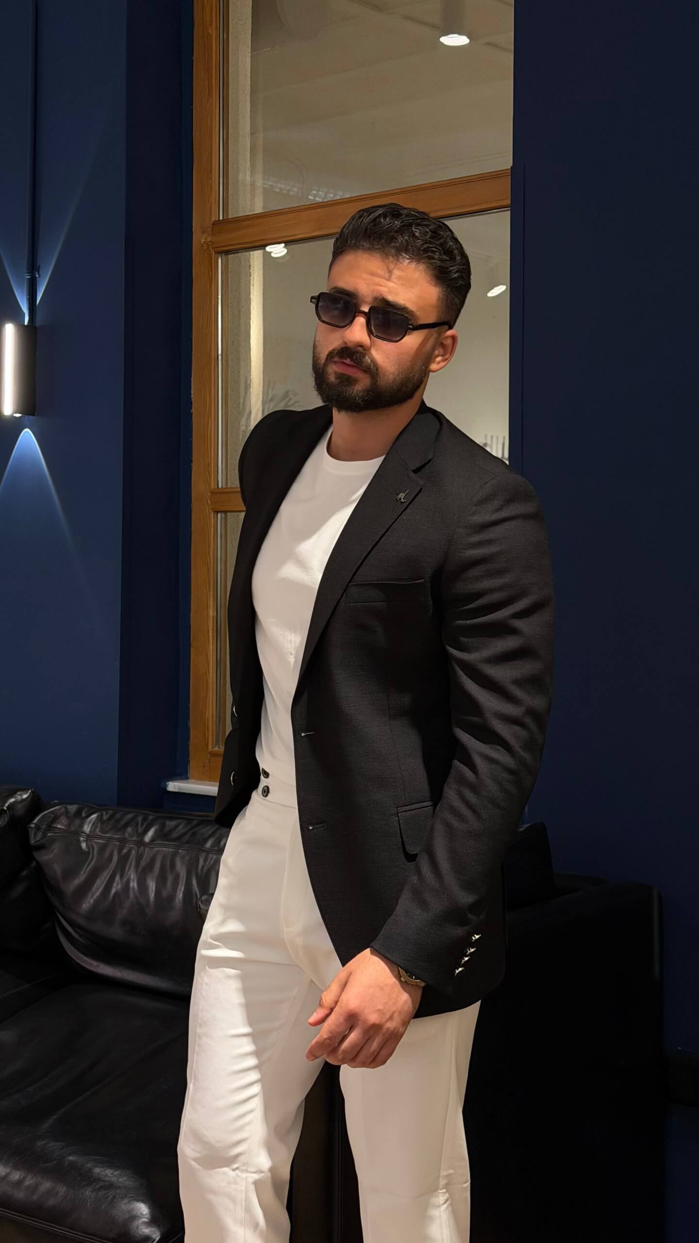 Men's black slim fit linen blend blazer styled with white trousers