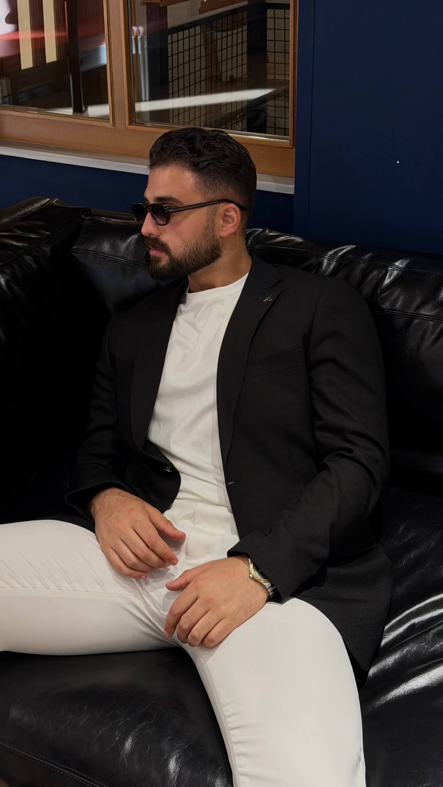 Men's black slim fit linen blend blazer styled with white trousers