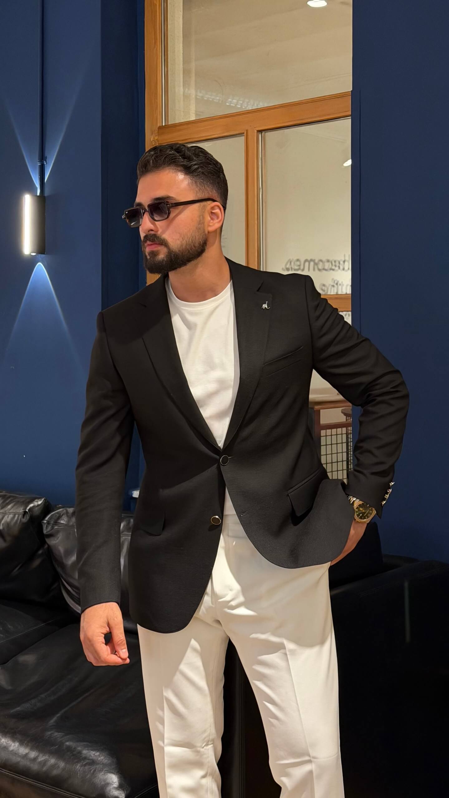 Men's black slim fit linen blend blazer styled with white trousers
