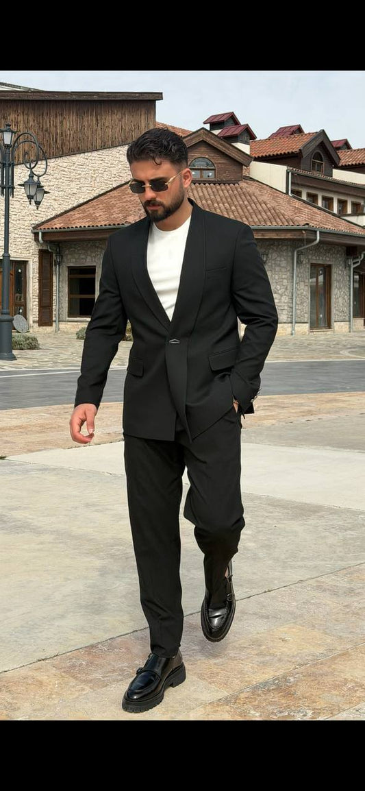 Black double-breasted shawl lapel slim-fit men’s suit worn with black slim trousers, perfect for formal events and weddings.