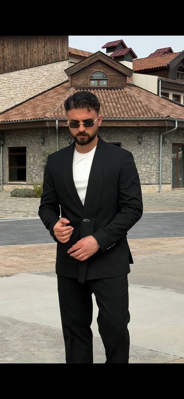 Black double-breasted shawl lapel slim-fit men’s suit worn with black slim trousers, perfect for formal events and weddings.