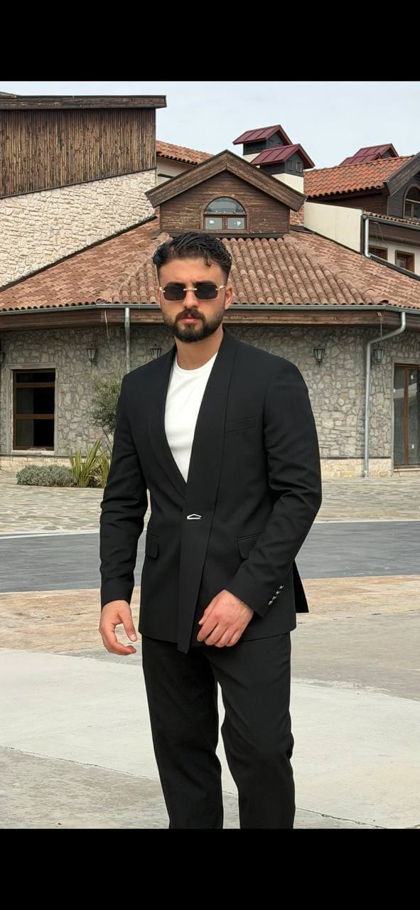 Black double-breasted shawl lapel slim-fit men’s suit worn with black slim trousers, perfect for formal events and weddings.