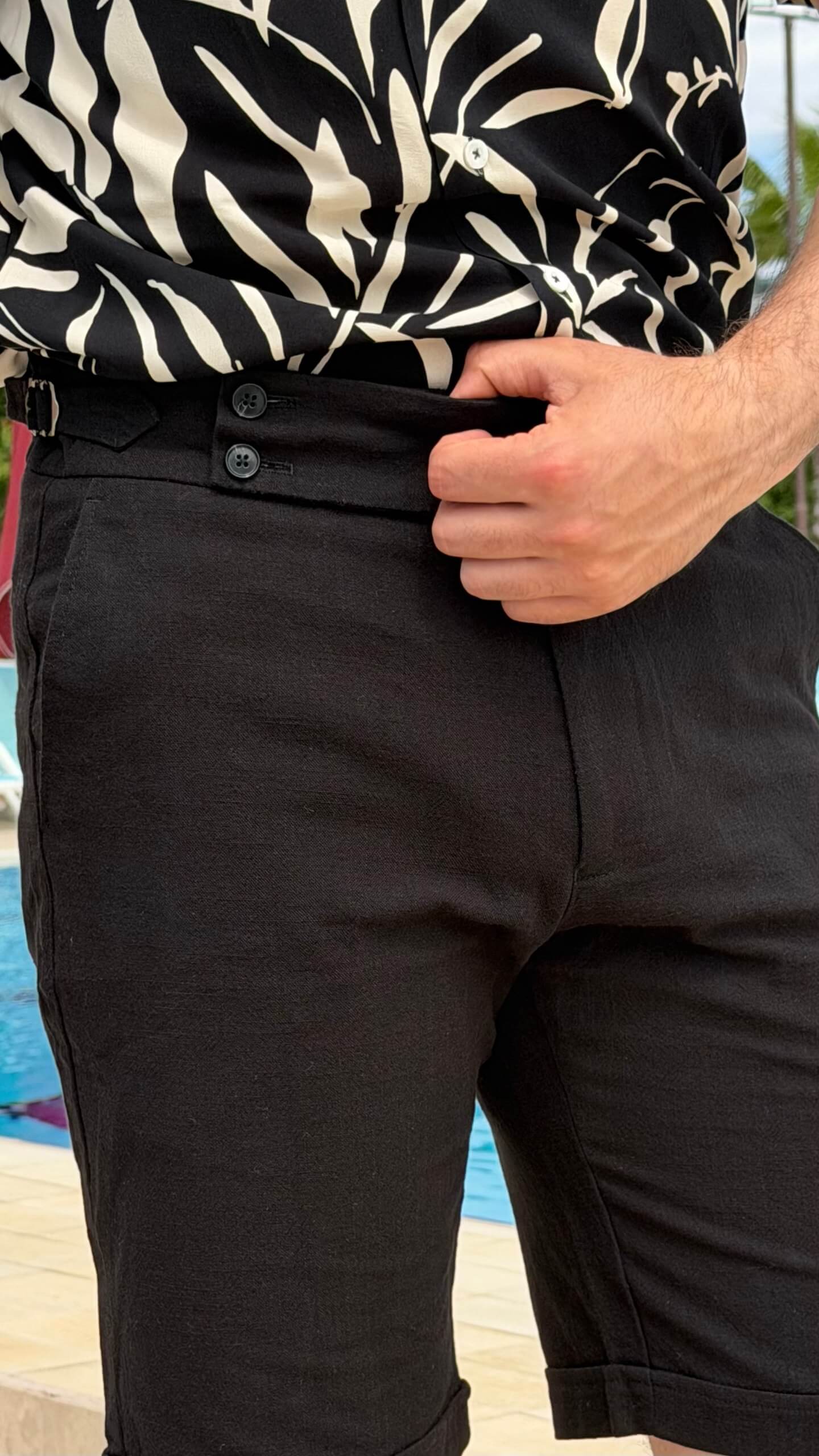 Men’s black slim fit linen shorts with tailored design, button closure, side pockets, lightweight fabric, and modern summer casual style.