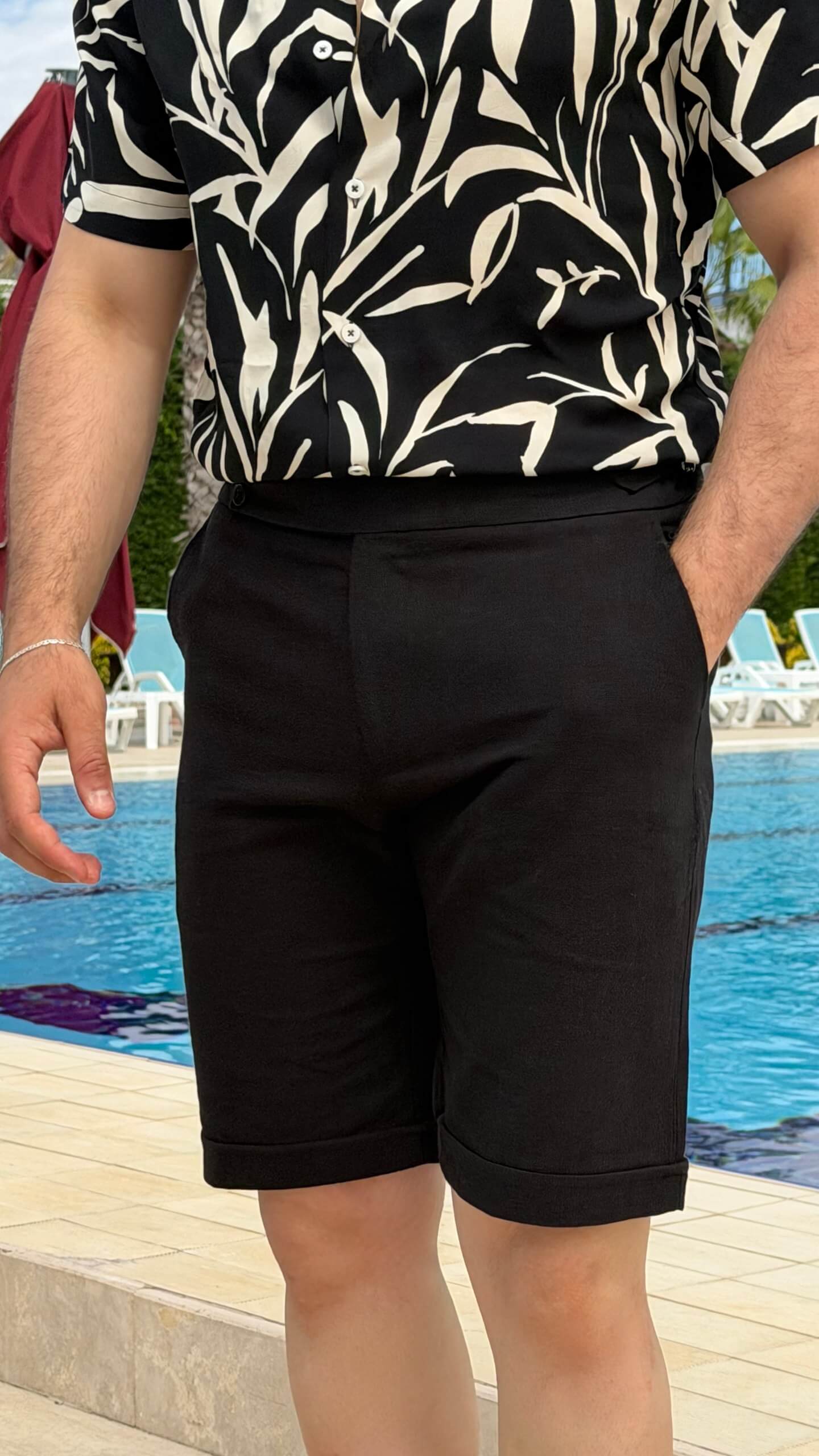 Men’s black slim fit linen shorts with tailored design, button closure, side pockets, lightweight fabric, and modern summer casual style.