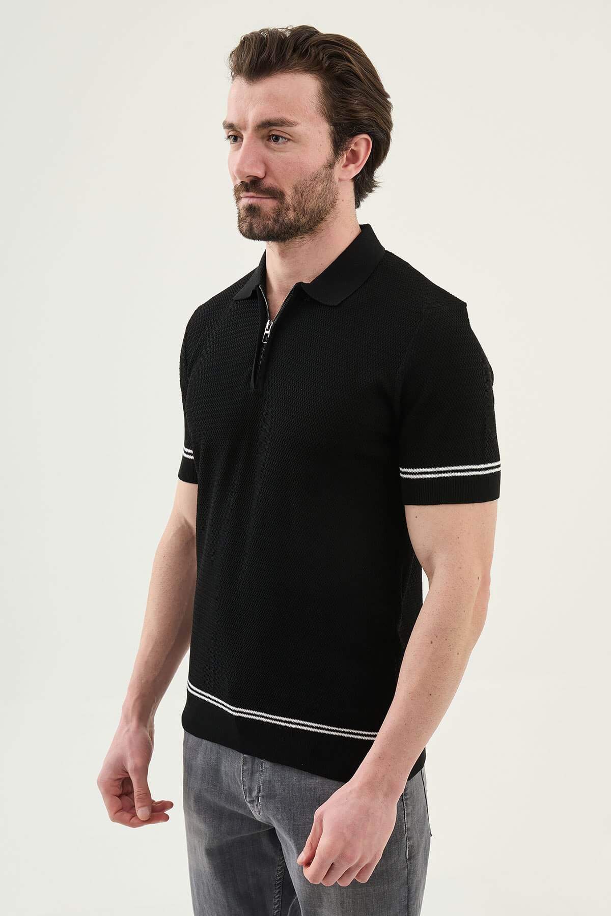 Man wearing a black slim-fit quarter-zip polo T-shirt, short sleeves, styled for summer casual wear, standing against a neutral background.