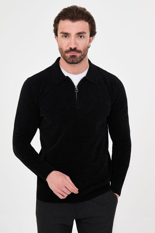 Men’s black polo neck knit sweater with zip collar detail styled with grey trousers for a refined fall winter smart-casual outfit.