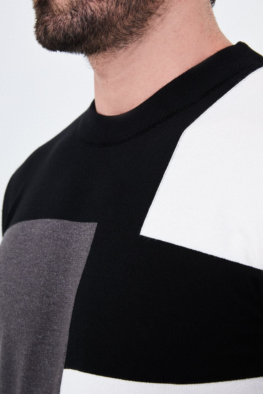 Men's black crew neck sweater with grey and white geometric colour-block panels.