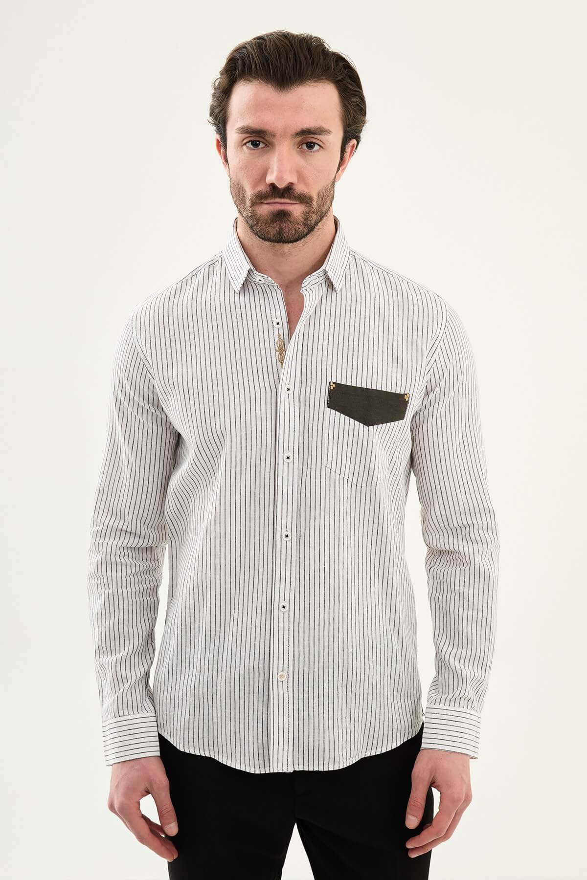 black textured slim-fit long sleeve shirt with contrast pocket panel, styled with light-colored trousers