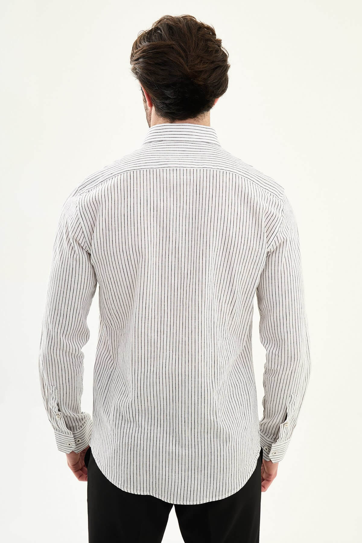 black textured slim-fit long sleeve shirt with contrast pocket panel, styled with light-colored trousers
