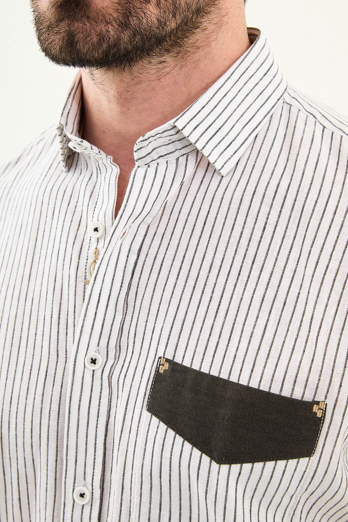 black textured slim-fit long sleeve shirt with contrast pocket panel, styled with light-colored trousers