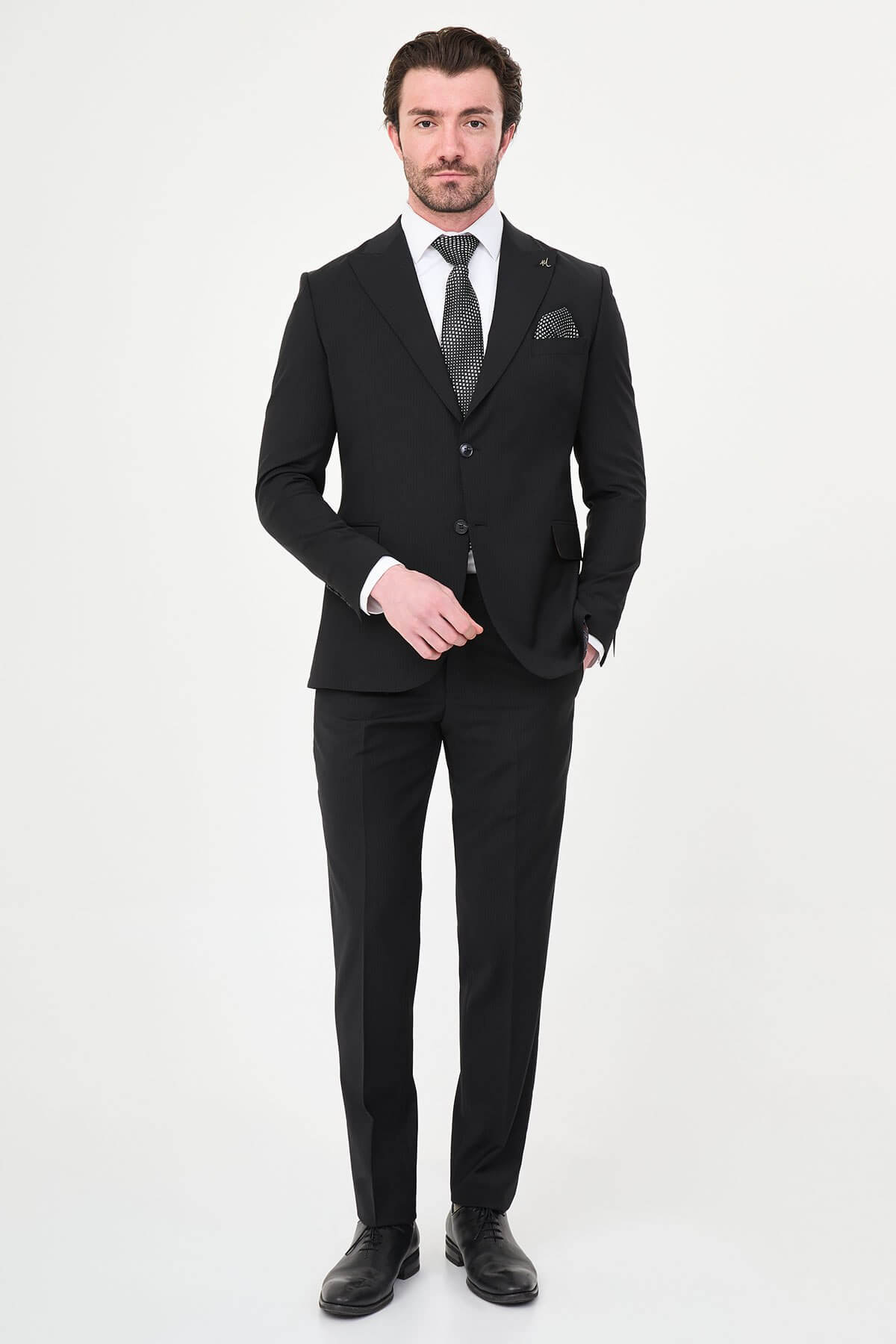 Men's Black Slim Fit Wide Collar Premium Wool Suit, featuring slim-fit tailored jacket, white dress shirt, patterned black tie, and pocket square.