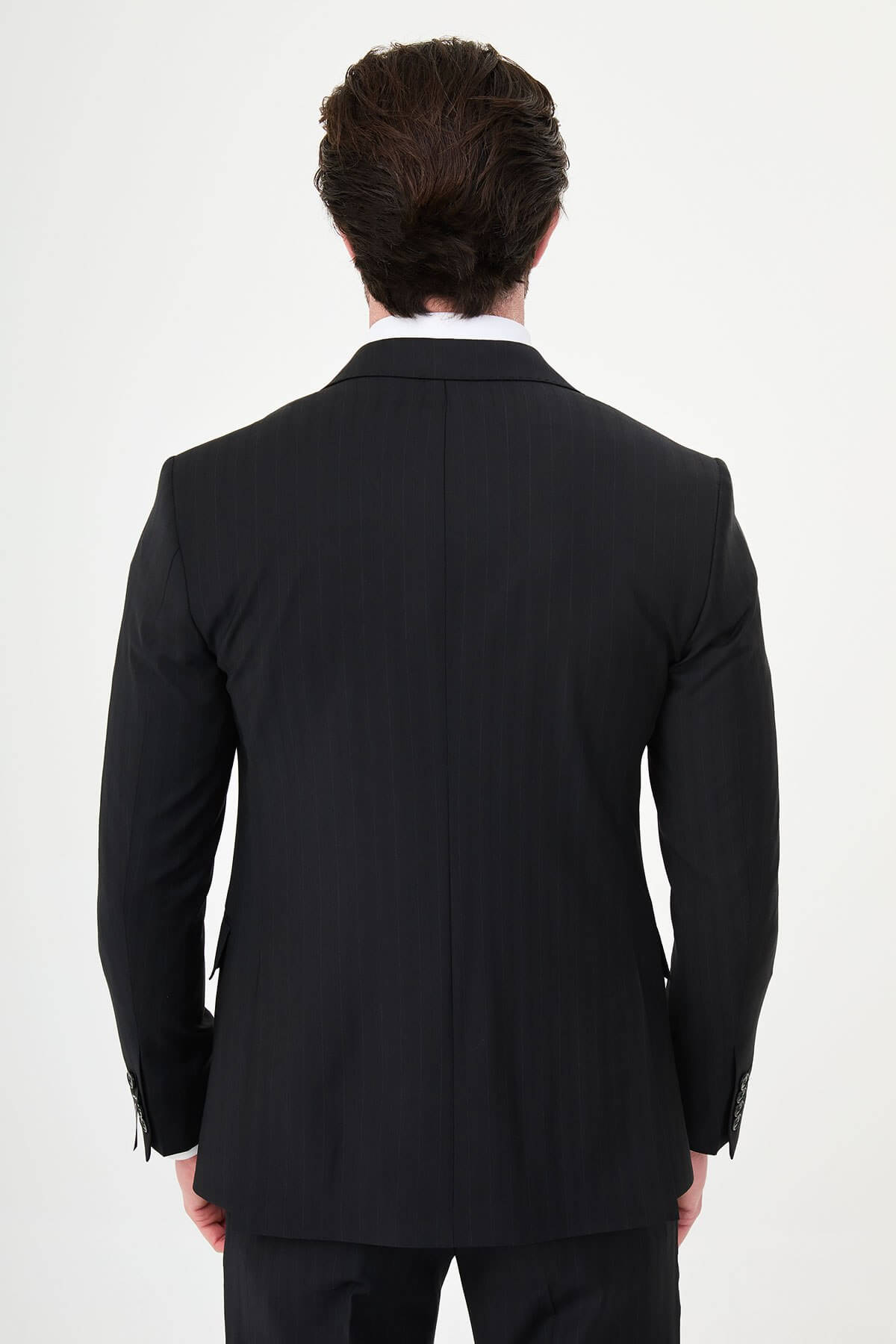 Man wearing a black slim fit wide collar premium wool suit with a patterned tie and pocket square