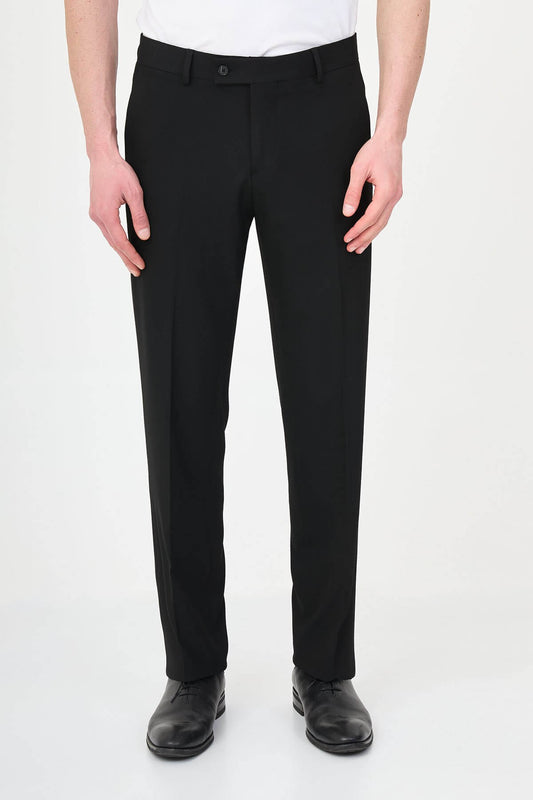 Man wearing black pleated dress trousers with straight slim fit, styled with a white dress shirt and black leather shoes.
