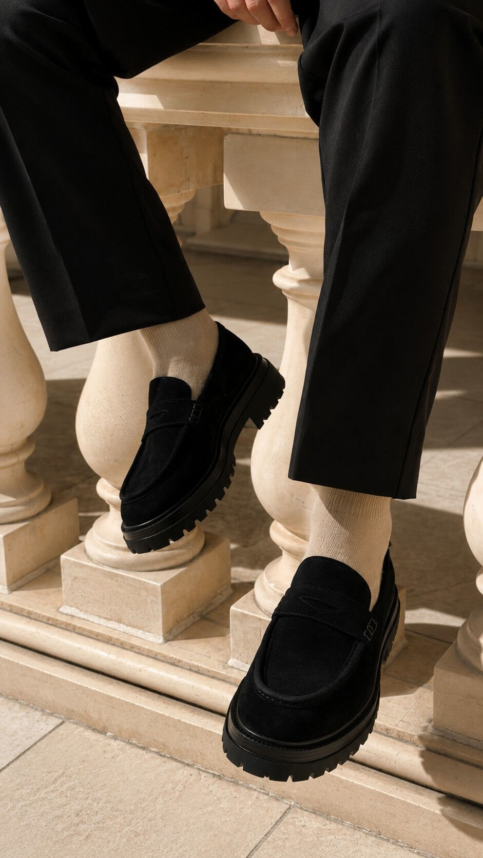 Black suede men's loafer, angled front and heel view