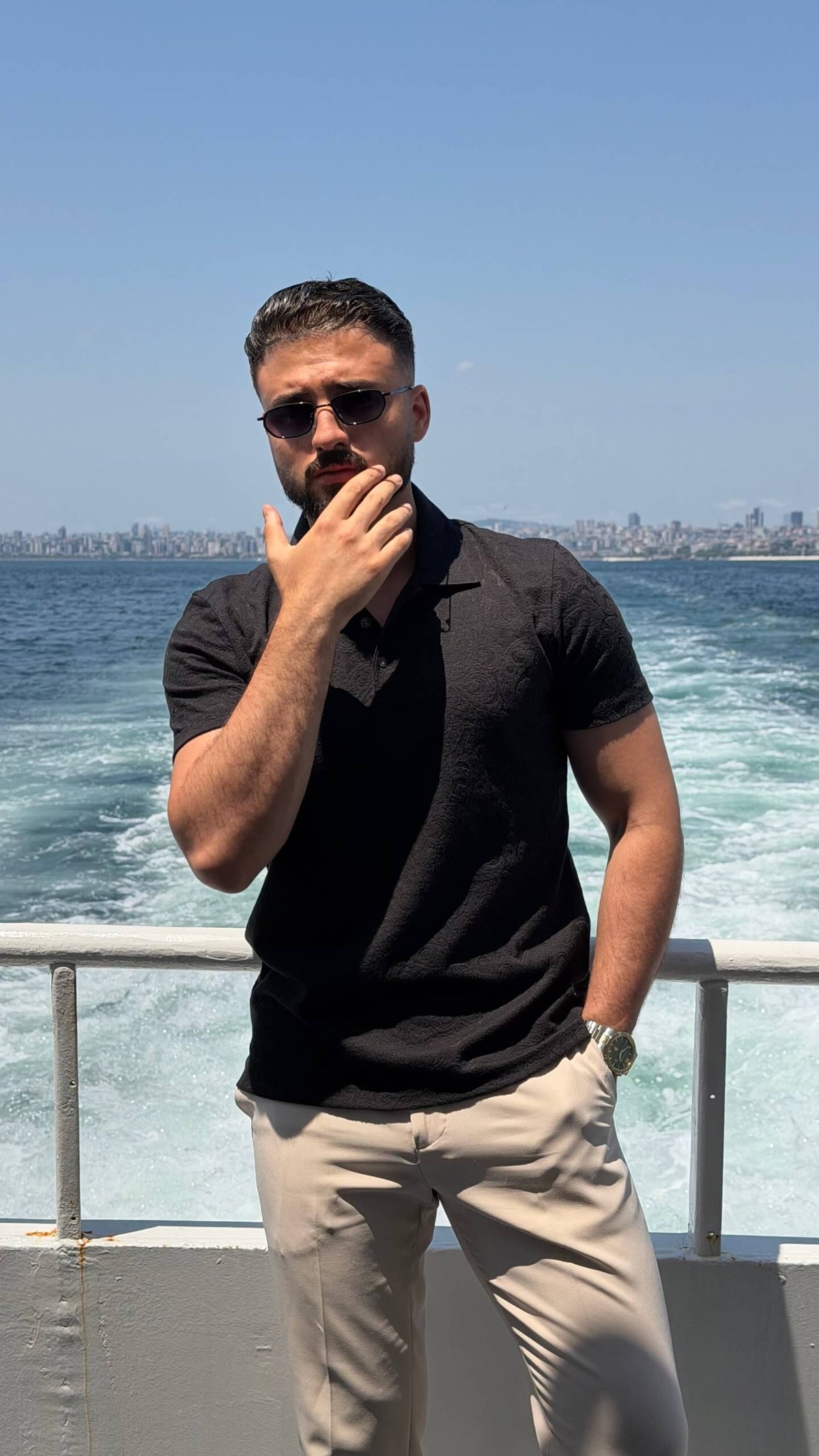 Men’s black textured knit polo shirt with short sleeves and modern smart casual design