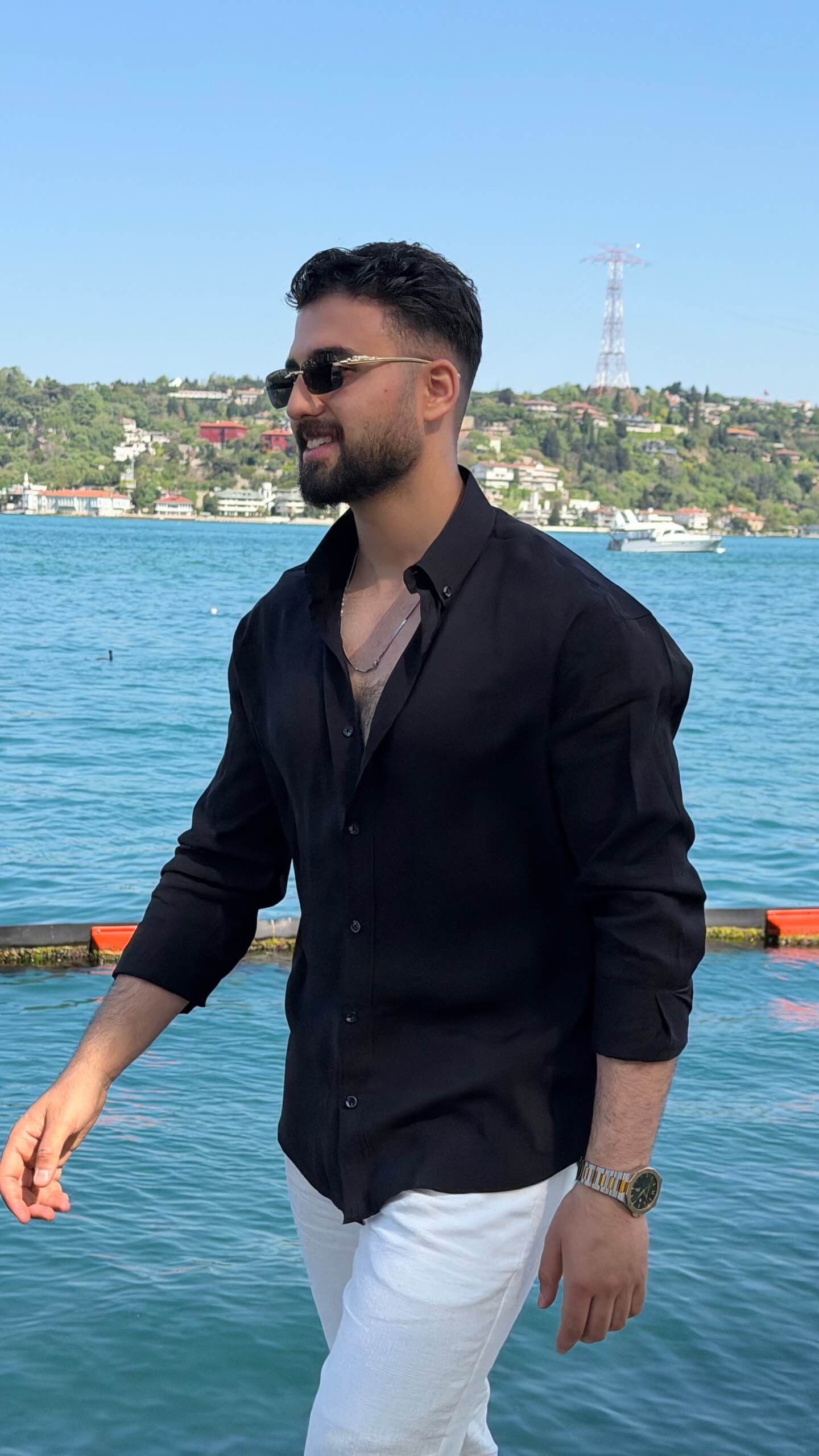 Black striped men's shirt styled for a smart casual outfit, back view