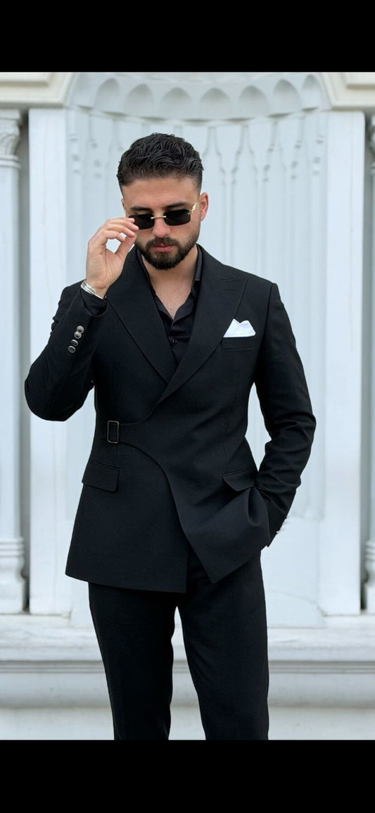 Black tailored slim fit suit styled with black shirt and pocket square. 