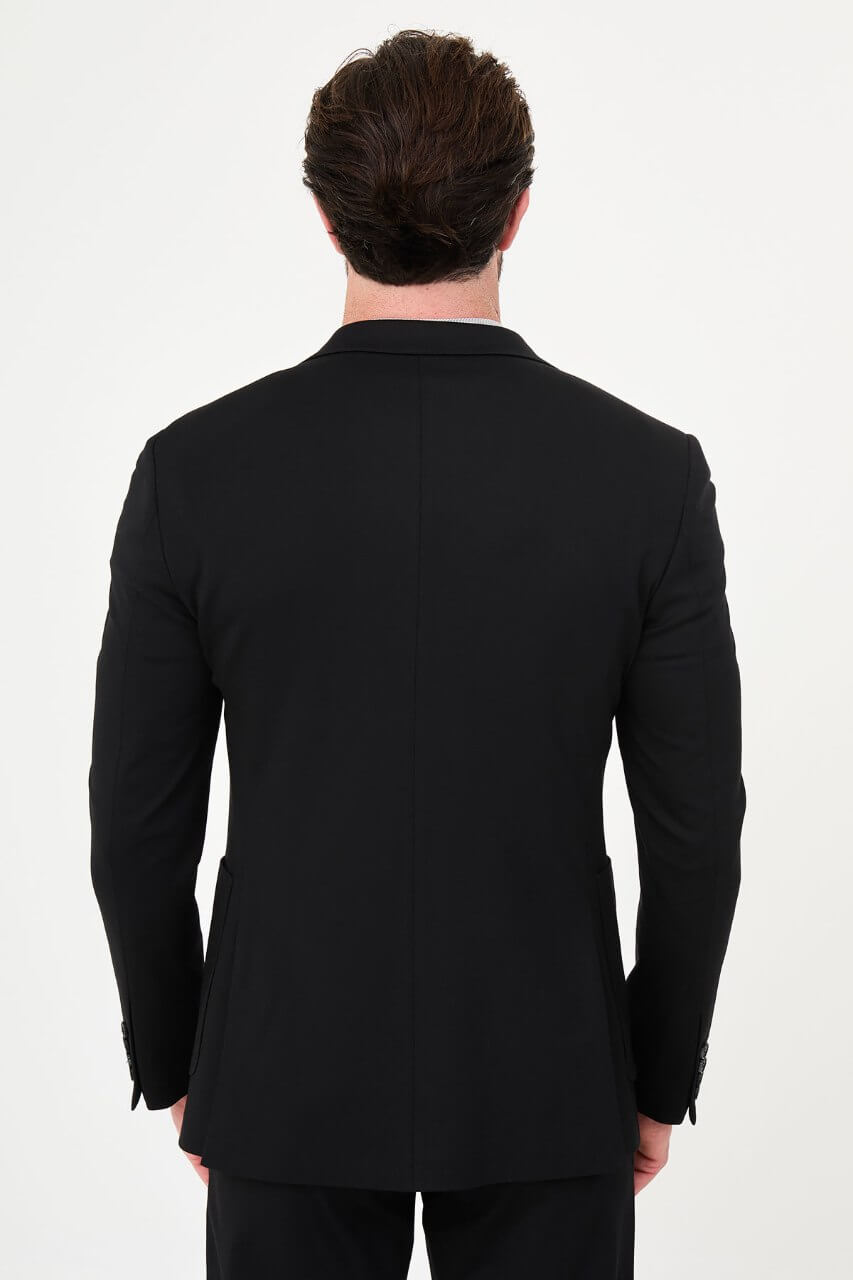 Men's black slim-fit casual suit with a two-button blazer, notch lapels and front patch pockets.