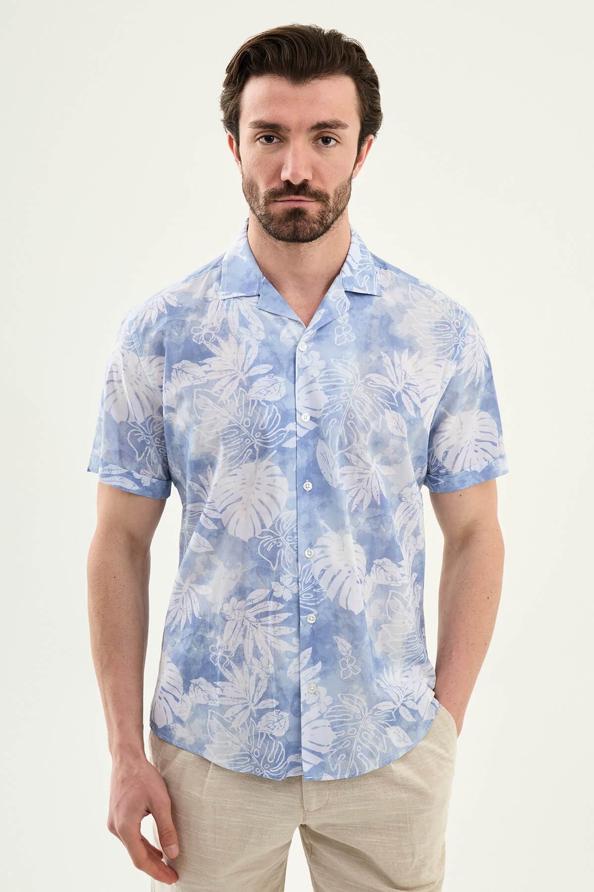 Men’s blue tropical print short sleeve shirt crafted from lightweight 100% cotton, designed for relaxed summer and resort wear styling.